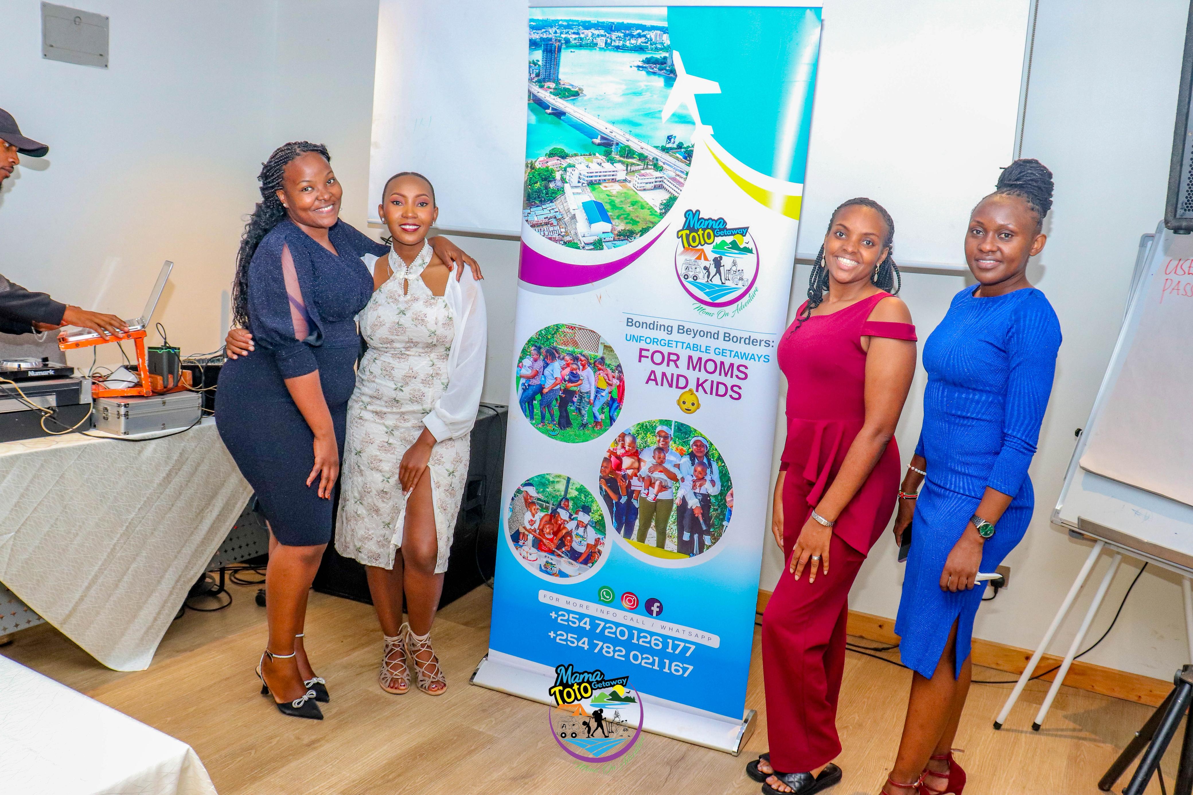 Moms posing with the Mama Toto placard